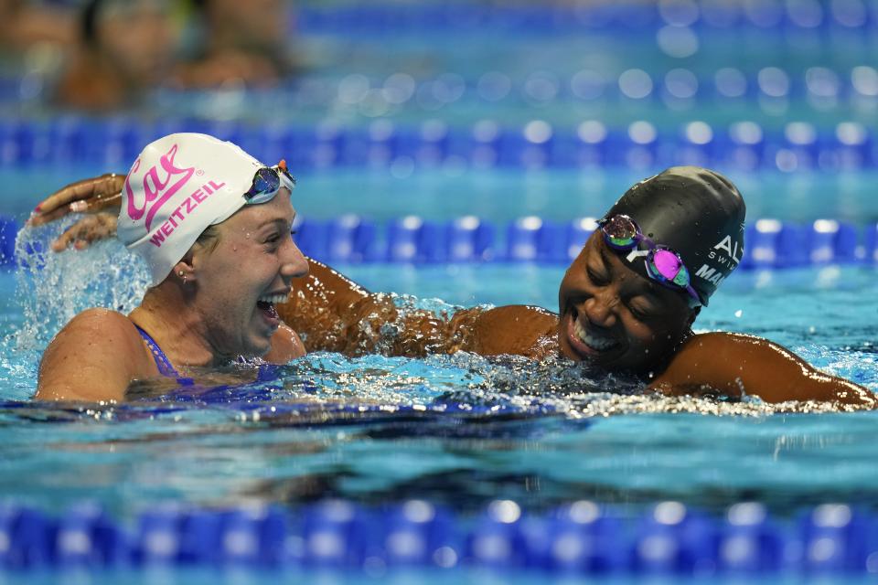 Simone Manuel and Abbey Weitzeil react after the women's 50 freestyle during wave 2 of the U.S. Olympic Swim Trials on Sunday, June 20, 2021, in Omaha, Neb. (AP Photo/Jeff Roberson)