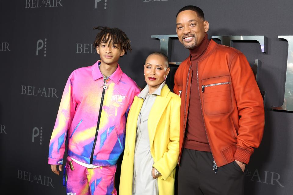 Jaden Smith standing next to parents Jada Pinkett Smith and Will Smith