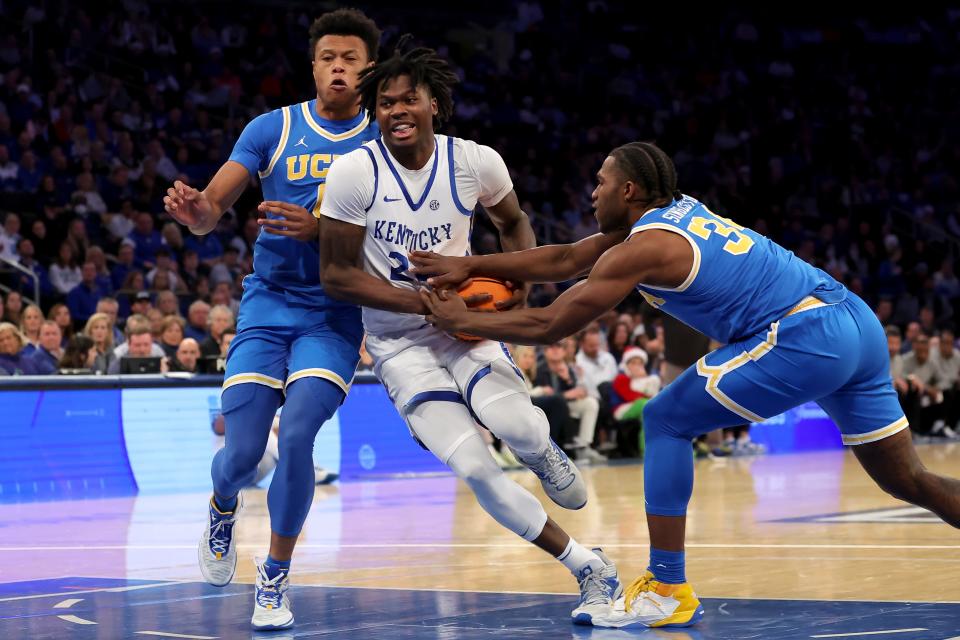 Dec 17, 2022; New York, New York, USA; Kentucky Wildcats forward Chris Livingston (24) drives to the basket against UCLA Bruins guard Jaylen Clark (0) and guard David Singleton (34) during the first half at Madison Square Garden. Mandatory Credit: Brad Penner-USA TODAY Sports