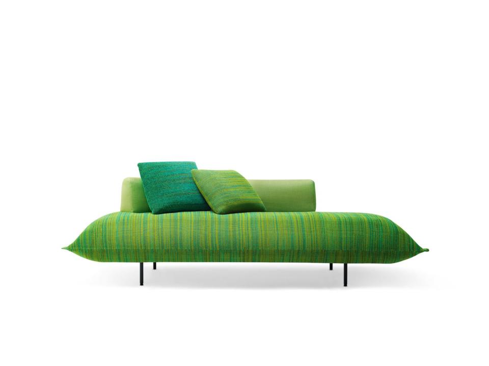 modern green sofa with no edges and stripey seat and matching pillows