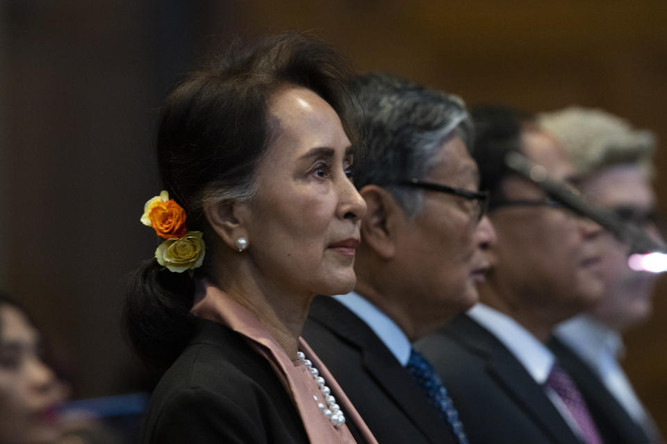 Myanmar's leader Aung San Suu Kyi stands in the court room of the International Court of Justice for the first day of three days of hearings in The Hague, Netherlands, Tuesday, Dec. 10, 2019. Aung San Suu Kyi will represent Myanmar in a case filed by Gambia at the ICJ, the United Nations' highest court, accusing Myanmar of genocide in its campaign against the Rohingya Muslim minority. (AP Photo/Peter Dejong)