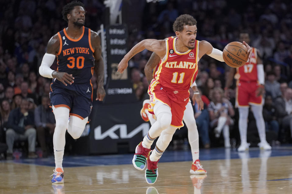 Atlanta Hawks guard Trae Young (11) brings the ball up past New York Knicks forward Julius Randle (30) during the first half of an NBA basketball game Wednesday, Nov. 2, 2022, at Madison Square Garden in New York. (AP Photo/Mary Altaffer)