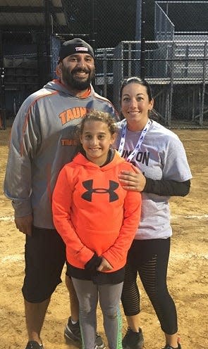Michelle Raposo, right, stands with her husband Jason Torres and daughter Mia after the Tigers won the 2018 Division I state championship in Worcester.