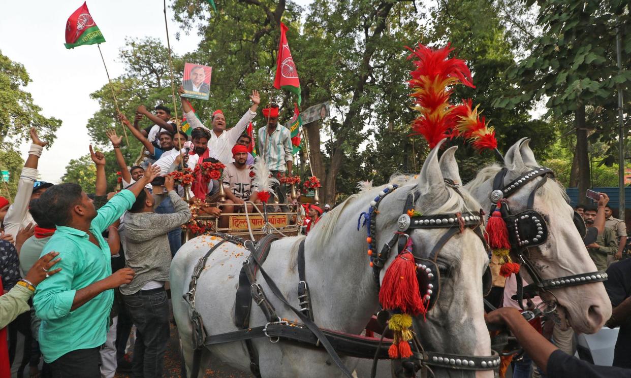 <span>Supporters of the Samajwadi party celebrate the results of India's general election, in Lucknow, Uttar Pradesh, on 4 June.</span><span>Photograph: AFP/Getty Images</span>