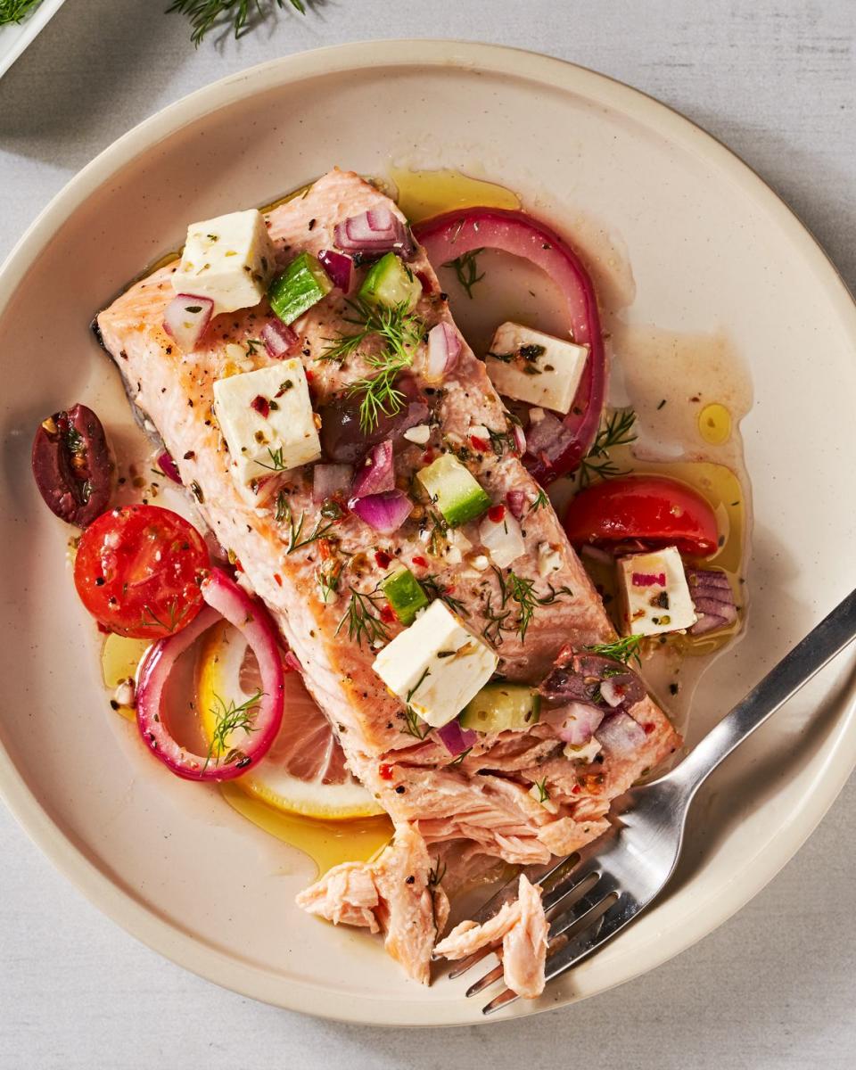 greek salmon with feta, tomatoes, lives, red onion, and cucumber