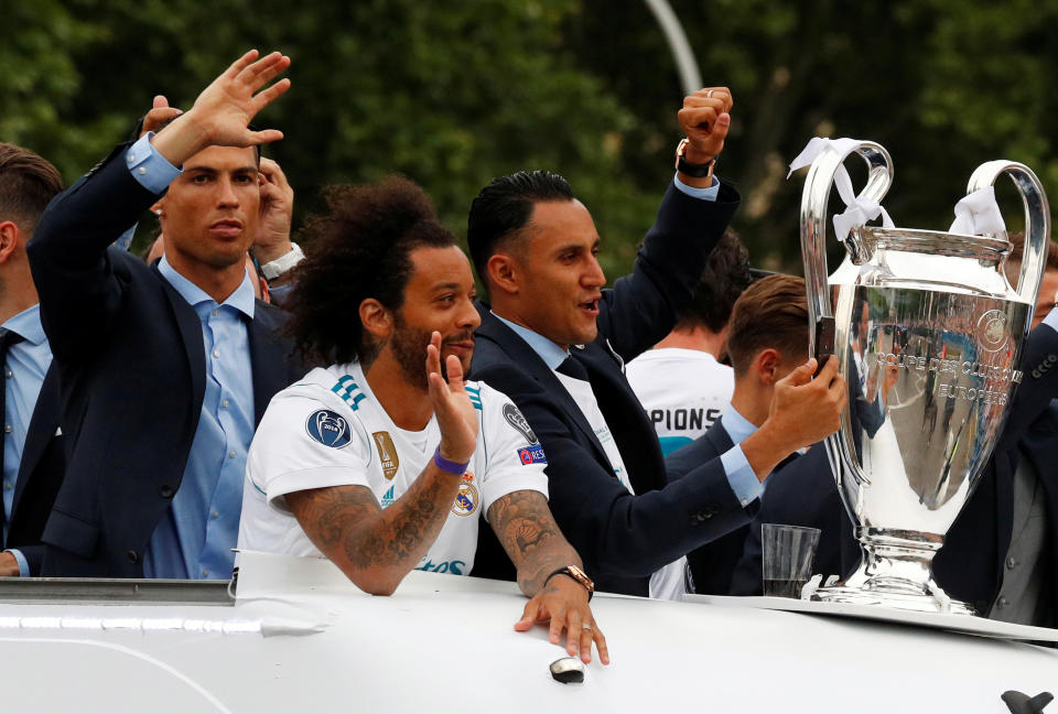 Soccer Football - Real Madrid celebrate winning the Champions League Final - Madrid, Spain - May 27, 2018   Real Madrid's Cristiano Ronaldo, Marcelo and Keylor Navas celebrate on the bus during victory celebrations   REUTERS/Paul Hanna