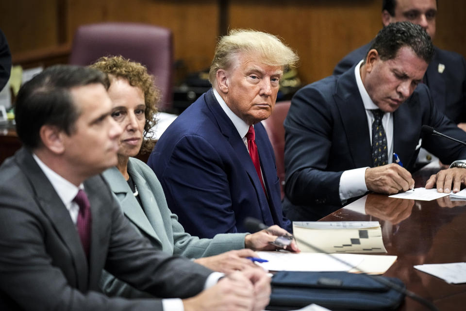 Image: Former President Donald Trump sits at the defense table with his defense team in a Manhattan court on April 4, 2023, in New York. (Seth Wenig / AP)