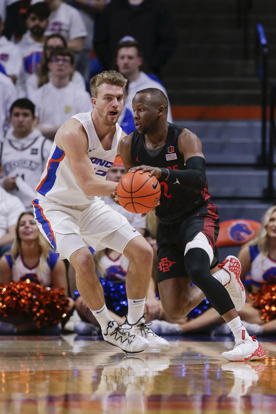 San Diego State guard Adam Seiko (2) drives against Boise State guard Max Rice (12) during the second half of an NCAA college basketball game Sunday, Feb. 16, 2020, in Boise, Idaho. San Diego State won 72-55. (AP Photo/Steve Conner)
