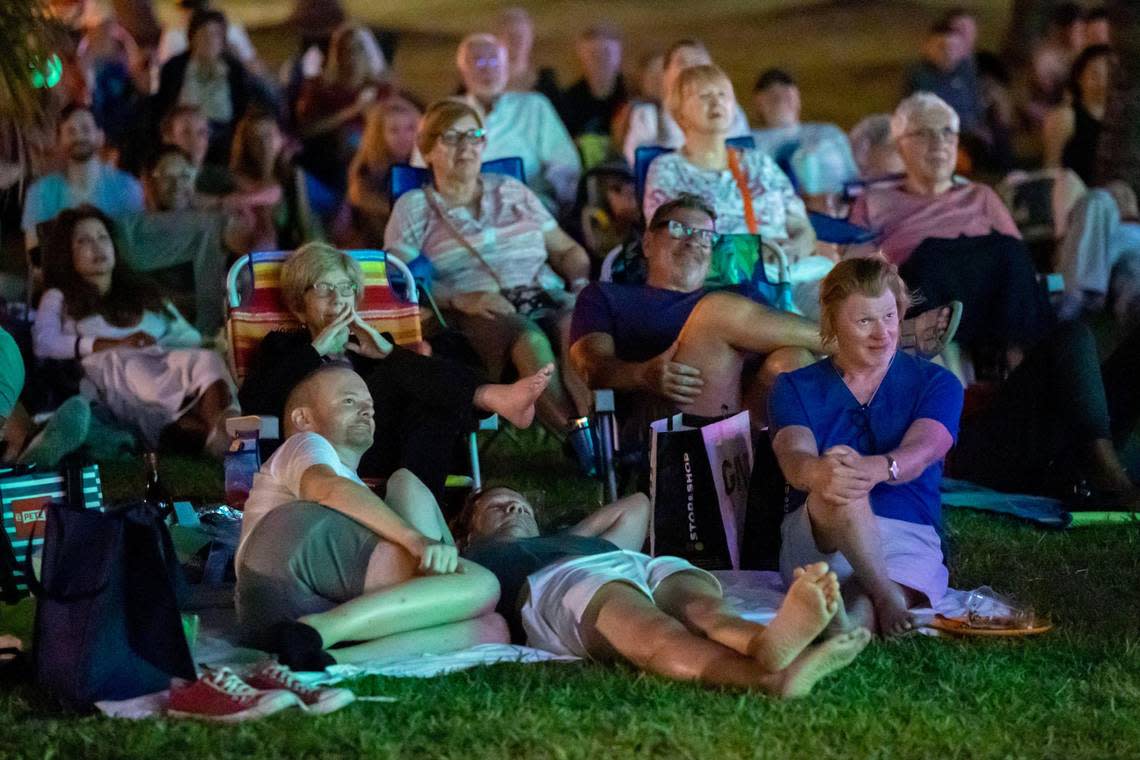 People watch “The Birdcage” as it is screened by the city of Miami Beach in Lummus Park on Friday, March 3, 2023.