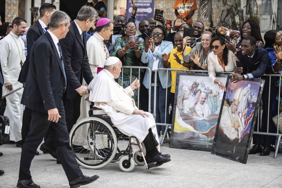 Pope Francis greets well-wishers before meeting with bishops in Kinshasa, Congo, Friday Feb. 3, 2023. Francis had one final appointment Friday in Kinshasa with Congo’s bishops before flying to the South Sudanese capital, Juba. (AP Photo/Moses Sawasawa)