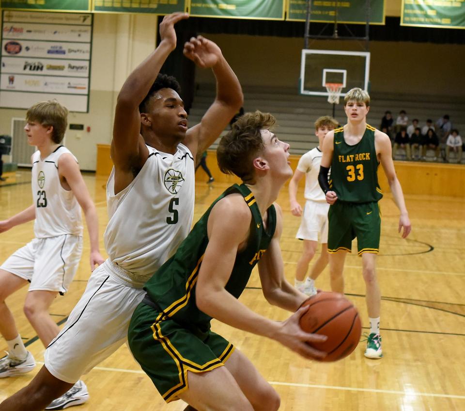 Tim Murphy of Flat Rock goes baseline to put the shot up underneath to score against St. Mary Catholic Central's Buddy Snodgrass Tuesday, Jan. 9, 2024. Flat Rock won the game 50-39.