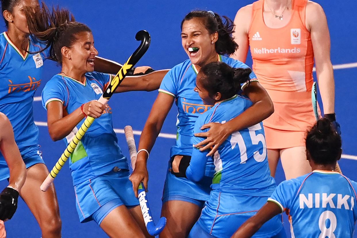 India's Rani (C) celebrates with teammates after scoring against Netherlands during their women's pool A match of the Tokyo 2020 Olympic Games field hockey competition, at the Oi Hockey Stadium in Tokyo on July 24, 2021.