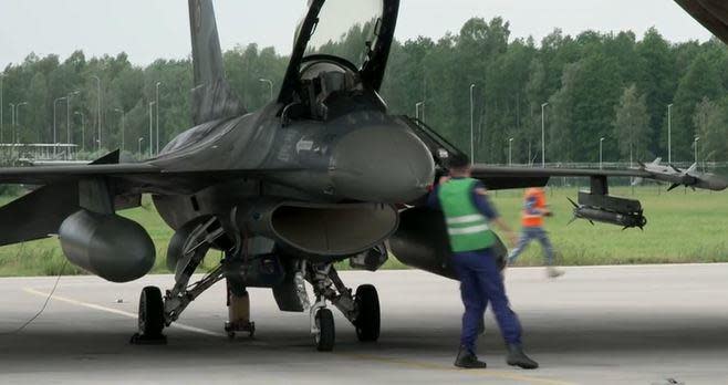 A flight crew from a U.S. NATO ally country scrambles to get airborne in an F-16 fighter jet during a training exercise at a base in eastern Europe. / Credit: CBS News