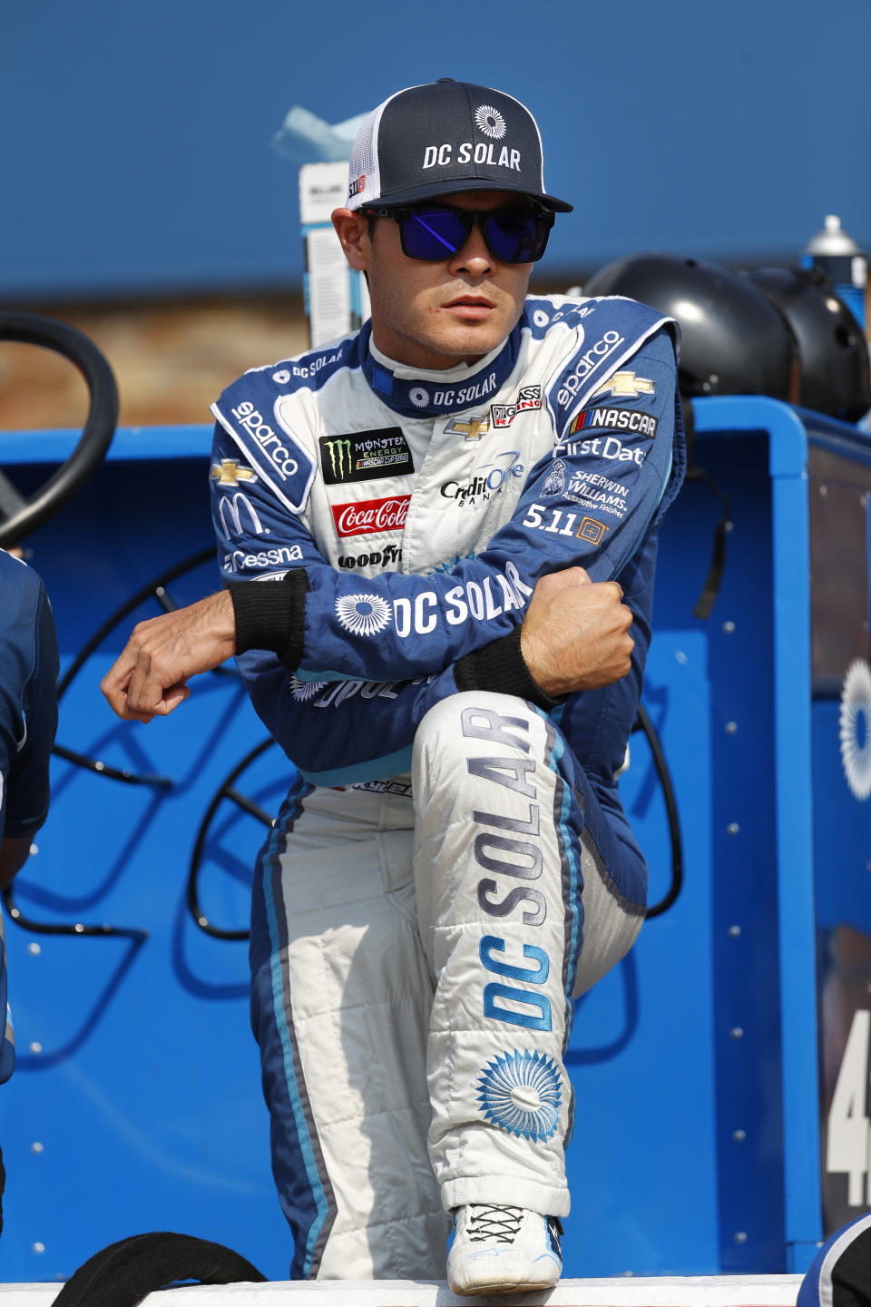 FILE - In this Aug. 10, 2018, file photo, Kyle Larson watches before qualifications for a NASCAR Cup Series auto race at Michigan International Speedway in Brooklyn, Mich. Kyle Larson was fired Tuesday, April 14, 2020, by Chip Ganassi Racing, a day after nearly every one of his sponsors dropped the star driver for using a racial slur during a live stream of a virtual race. Larson, in his seventh Cup season with Ganassi and considered the top free agent in NASCAR mere weeks ago, is now stunningly out of a job in what could ultimately be an eight-figure blunder by the star. (AP Photo/Paul Sancya, File)