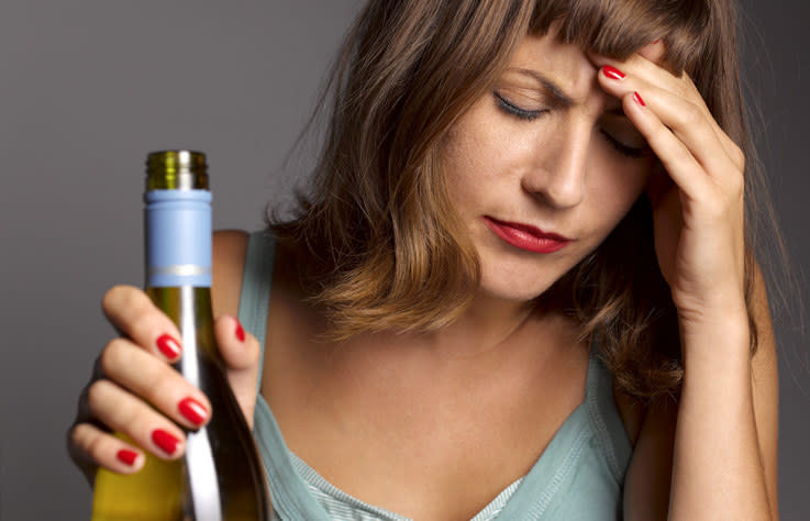 woman holding a bottle of wine