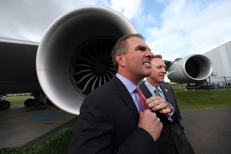 Lufthansa CEO Carsten Sporh adjust his tie as he stands with Boeing senior vice president Pat Shanahan before delivery by Boeing of the first 747-8 Intercontinental Tuesday, May 1, 2012, in Everett, Wash. Lufthansa is the launch customer for the Intercontinental and will start service with the airplane between Frankfurt, Germany and Washington, D.C. The 747-8 Intercontinental is a stretched, updated version of the iconic 747 and is expected to bring double-digit improvements in fuel burn and emissions over its predecessor, the 747-400, and generate 30 percent less noise. Boeing delivered the first 747-8 Intercontinental to a private customer in February, more than a year after originally planned. (AP Photo/Elaine Thompson)