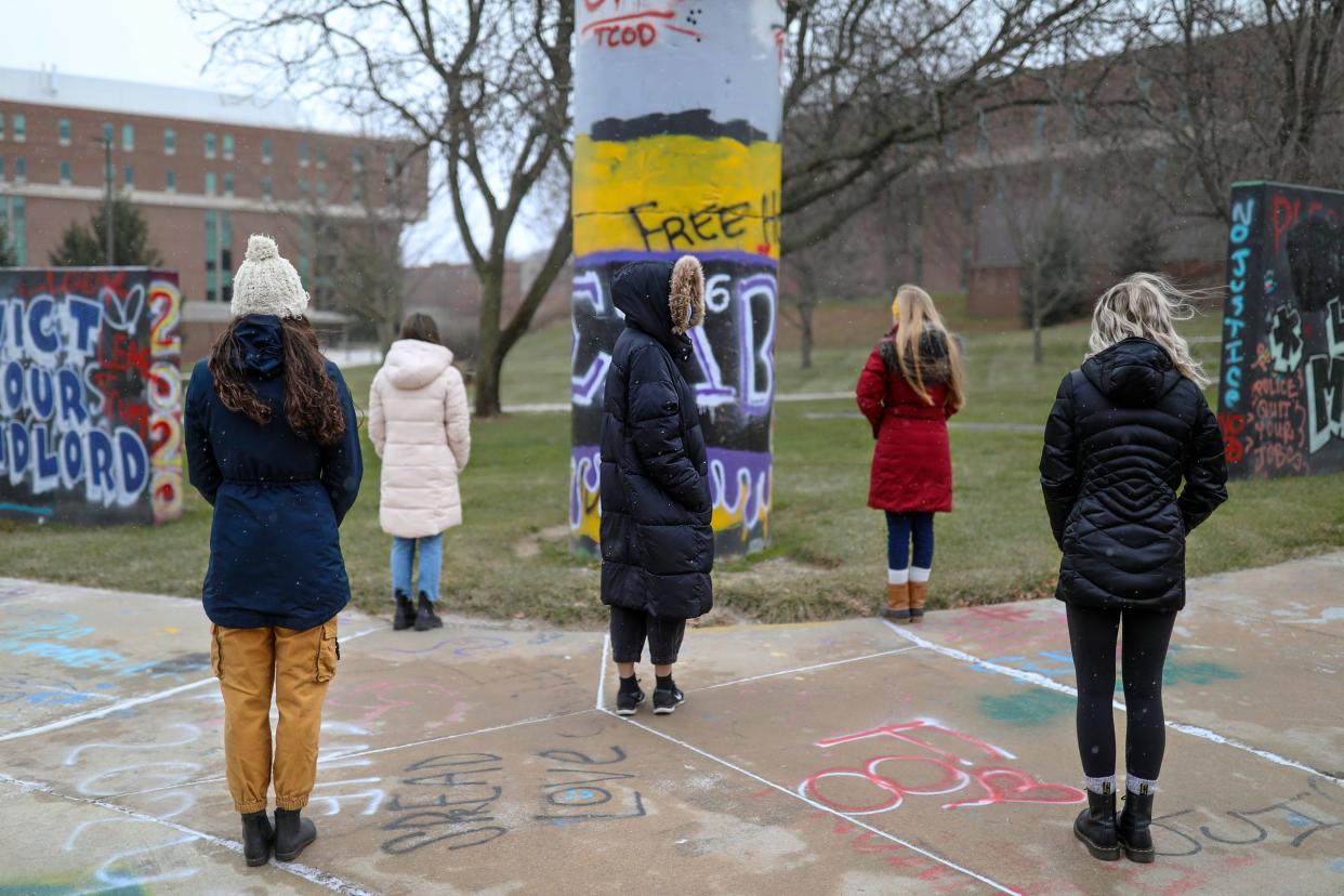 Five women, who came forward to testify about sexual assault they experienced, now lean on one another for support and are photographed on Wednesday, Dec. 16, 2020, on the Eastern Michigan University campus, where the rapes occurred while they were students.