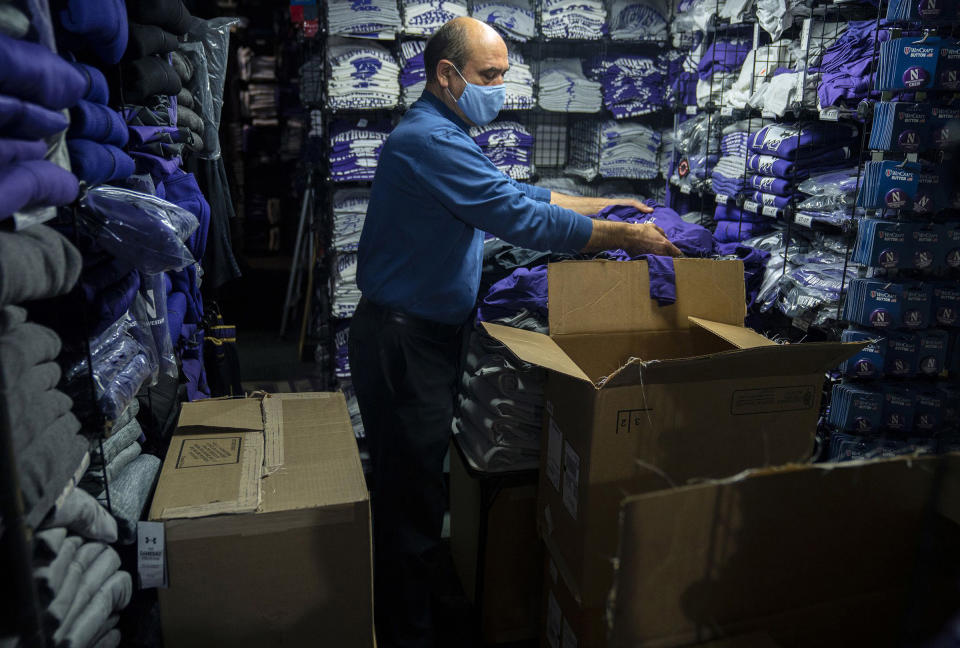 David Haghnaji, owner of Campus Gear in downtown Evanston, Ill., stocks another of his locations—The Locker Room, across from Ryan Field—with new Northwestern gear on Oct. 15, 2020.<span class="copyright">E. Jason Wambsgans—Chicago Tribune/TNS/Sipa USA</span>