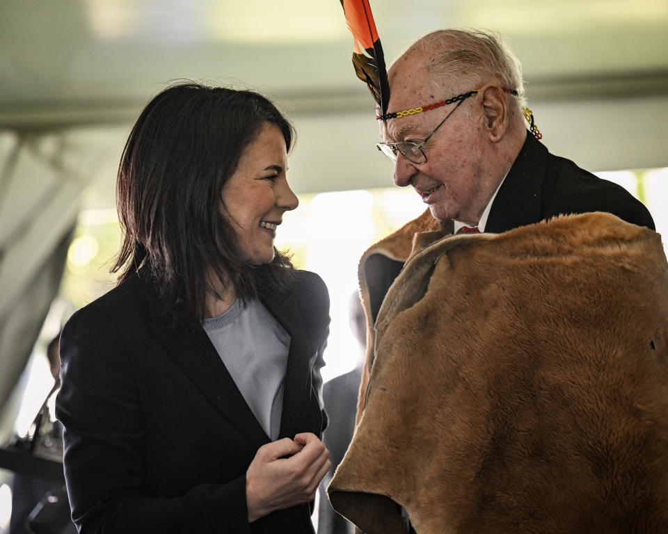 Germany's Minister for Foreign Affairs Annalena Baerbock, left, speaks with Lewis O'Brien, the oldest living Kaurna man, in Adelaide, Friday, May 3, 2024, during a ceremony to mark the return of four significant cultural heritage items to the Kaurna people from the collection of the Grassi Museum in Leipzig. (Michael Errey/Pool Photo via AP)