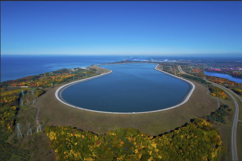 This undated photo provided by Consumers Energy shows an aerial view of the Ludington Pumped Storage Plant near Ludington, Mich. The plant generates electricity by pumping water from Lake Michigan to a reservoir on top of a bluff, then releasing it through giant turbines as needed. Advocates of pumped storage call such facilities the "world's largest batteries." (AP Photo/Consumers Energy)