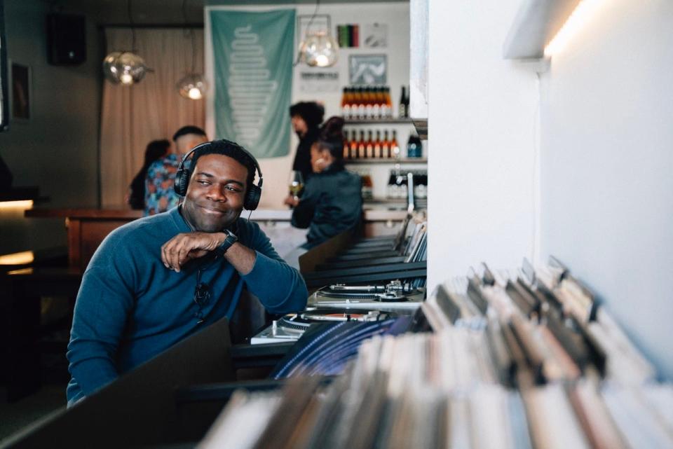 Sam Richardson listens to some vinyl at Paramita Sound, a hybrid record store and wine bar, as part of a promotional campaign for Detroit ahead of the NFL draft.