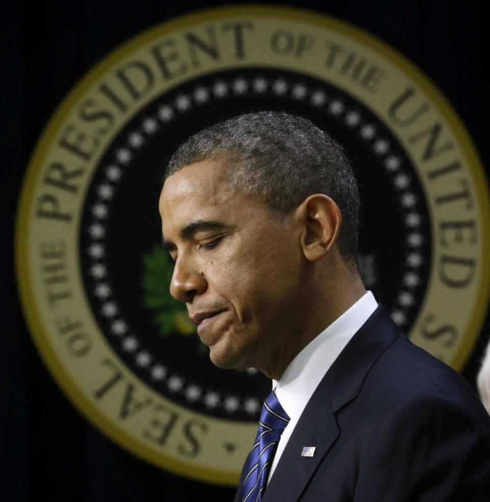 With the presidential seal on the wall in the background, President Barack Obama pauses in the Eisenhower Executive Office Building, on the White House campus in Washington, Wednesday, Nov. 28, 2012, where he spoke about how middle class Americans would see their taxes go up if Congress fails to act to extend the middle class tax cuts. The president said he believes that members of both parties can reach a framework on a debt-cutting deal before Christmas. (AP Photo/Pablo Martinez Monsivais)