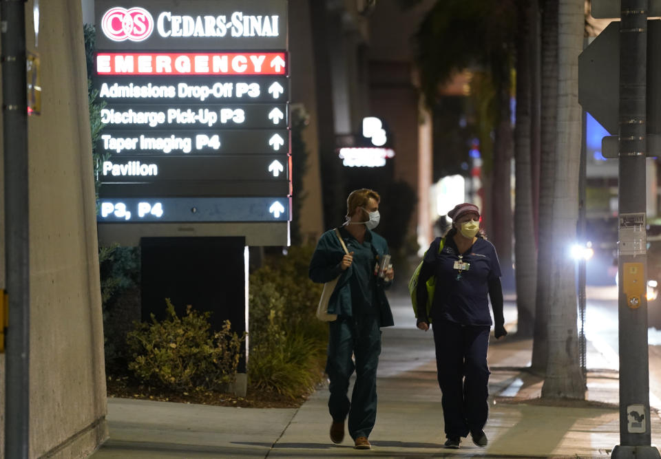 Cedars-Sinai Medical Center workers walk outside the hospital, late Tuesday, Jan. 5, 2021, in Los Angeles. Music producer and hip hop legend Dr. Dre is hospitalized in the intensive care unit at Cedars-Sinai after suffering a brain aneurysm Monday. (AP Photo/Chris Pizzello)