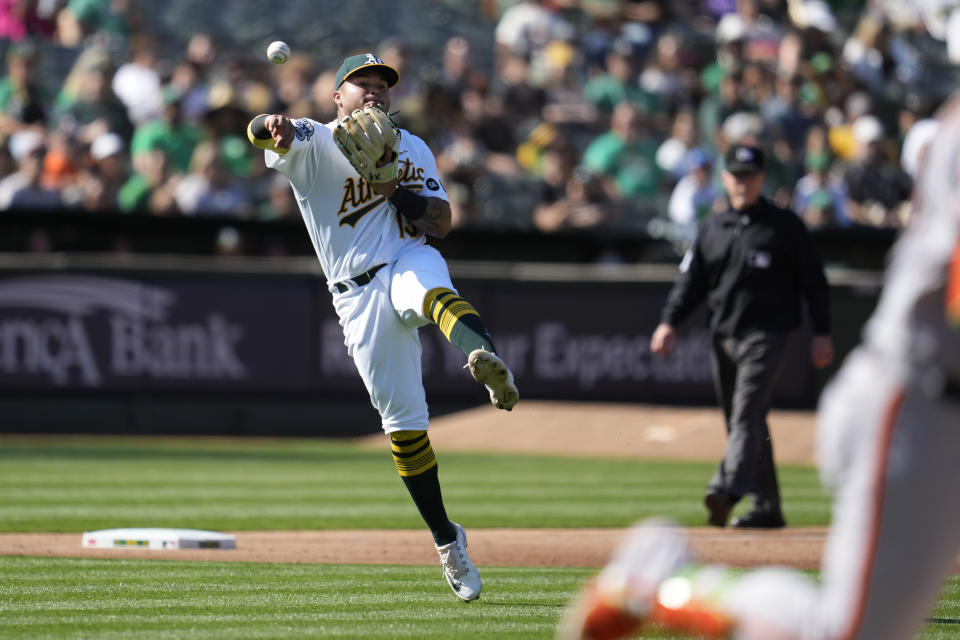 Oakland Athletics third baseman Jordan Diaz throws out San Francisco Giants' Joc Pederson at first base during the third inning of a baseball game in Oakland, Calif., Saturday, Aug. 5, 2023. (AP Photo/Jeff Chiu)