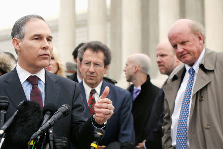 Attorney General of Oklahoma Scott Pruitt (L), a critic of the U.S. government in the King v. Burwell case, speaks to reporters after arguments at the Supreme Court building in Washington, DC, U.S. March 4, 2015. Also pictured are the plaintiffs' attorneys Sam Kazman (C) and Michael Carvin (R). REUTERS/Jonathan Ernst/File Photo