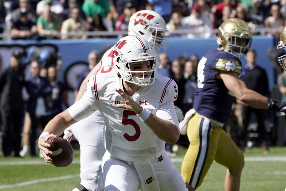 Wisconsin quarterback Graham Mertz scrambles during the first half of an NCAA college football game against Notre Dame Saturday, Sept. 25, 2021, in Chicago. (AP Photo/Charles Rex Arbogast)