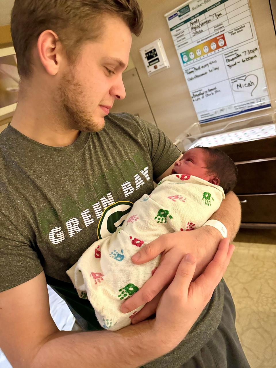 Daniel Beck in the hospital holding baby Micah.