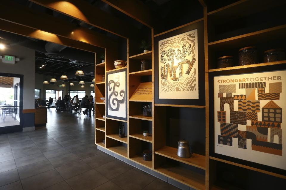 This Wednesday, Jan. 15, 2020, photo shows a Starbucks Community Store, which offers more space for patrons and a community meeting space, in Phoenix. The Seattle-based company plans to open or remodel 85 stores by 2025 in rural and urban communities across the U.S. That will bring to 100 the total number of community stores Starbucks has opened since it announced the program in 2015. (AP Photo/Ross D. Franklin)