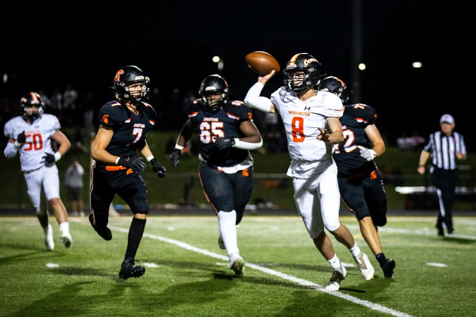 Washington quarterback Ethan Patterson (8) looks to pass as Solon's Ben Kampman (7) Joe Ebert (65) and Aidan Doyle bring pressure. The Spartans recorded their second consecutive shutout, and third of the season.