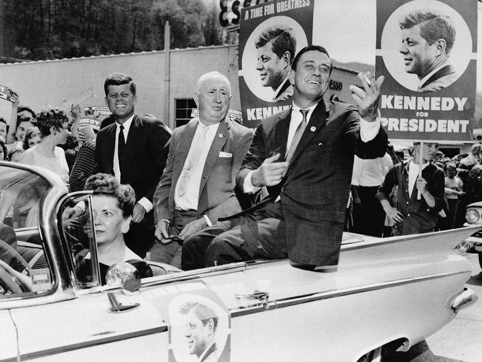 Sen. John F. Kennedy, left, is accompanied by his West Virginia campaign chairman, State Senator Ward Wylie, center, and Franklin D. Roosevelt Jr., right, as he tours Mullens, W. Va., during his bid for presidency, April 27, 1960.