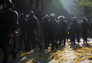 Police officer walk to detain demonstrators during an opposition rally to protest the official presidential election results in Minsk, Belarus, Saturday, Sept. 26, 2020. Hundreds of thousands of Belarusians have been protesting daily since the Aug. 9 presidential election. (AP Photo/TUT.by)