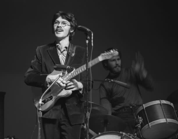 <p>Harvey L. Silver/Corbis via Getty</p> Robbie Robertson and drummer Levon Helm of The Band perform during a concert at Queens College in New York