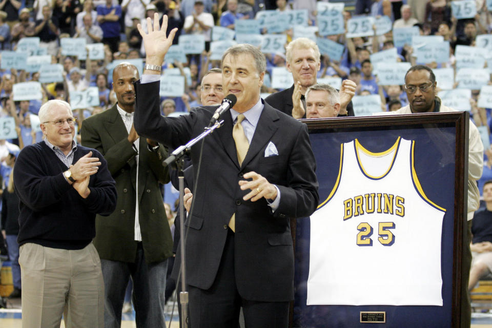 FILE - In this Dec. 18, 2004, file photo, former UCLA basketball player Gail Goodrich, foreground, waves to the crowd during a ceremony retiring his UCLA No. 25 jersey at half time of the UCLA-Michigan game in Los Angeles. More than three decades after the 1988 NBA All-Star weekend in Chicago, some details of the classic slam dunk contest showdown between Michael Jordan and Dominique Wilkins are a bit fuzzy to Hall of Famer Gail Goodrich. One of five judges for the competition, the former Los Angeles Lakers' great is, however, certain of a few things: His Airness soared to a slightly higher level than the Human Highlight Reel, there was no pressure to crown Jordan the slam dunk king on his home court and the judges were not in cahoots.(AP Photo/Francis Specker, File)