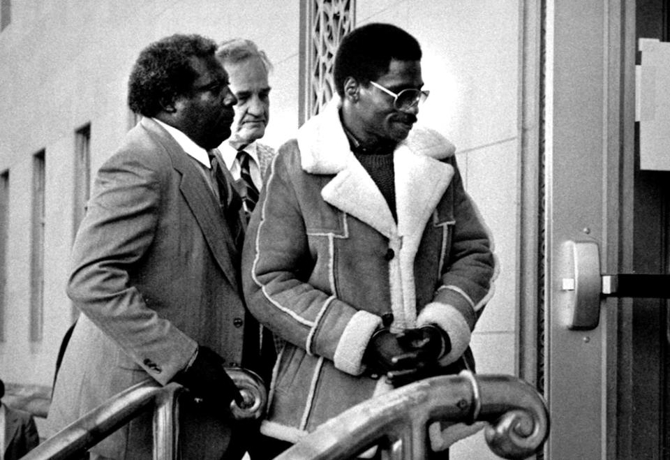 FILE - In this Nov. 8, 1985 file photo, Rubin "Hurricane" Carter, right, the former middleweight boxer, is escorted into federal court in Newark, N.J. Carter, who spent almost 20 years in jail after twice being convicted of a triple murder he denied committing, died at his home in Toronto, Sunday, April 20, 2014, according to long-time friend and co-accused John Artis. He was 76. (AP Photo/File)