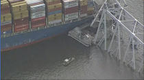 Parts of the Francis Scott Key Bridge remain after a container ship collided with one of the bridge’s support Tuesday, March 26, 2024 in Baltimore. The major bridge in Baltimore snapped and collapsed after a container ship rammed into it early Tuesday, and several vehicles fell into the river below. Rescuers were searching for multiple people in the water. (WJLA via AP)