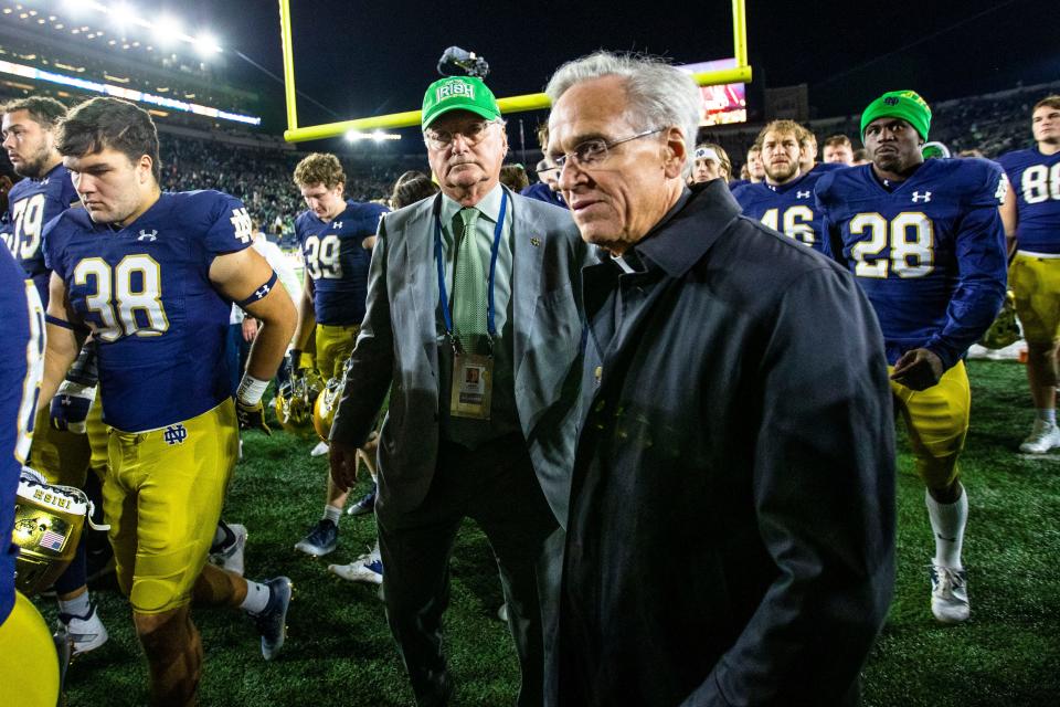 Notre Dame athletic director Jack Swarbrick and Rev. John I. Jenkins, C.S.C. walk off the field after the Notre Dame vs. Stanford NCAA football game Saturday, Oct. 15, 2022 at Notre Dame Stadium in South Bend.