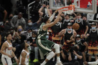 Milwaukee Bucks' Giannis Antetokounmpo (34) dunks during the first half of Game 3 of basketball's NBA Finals against the Phoenix Suns, Sunday, July 11, 2021, in Milwaukee. (AP Photo/Aaron Gash)