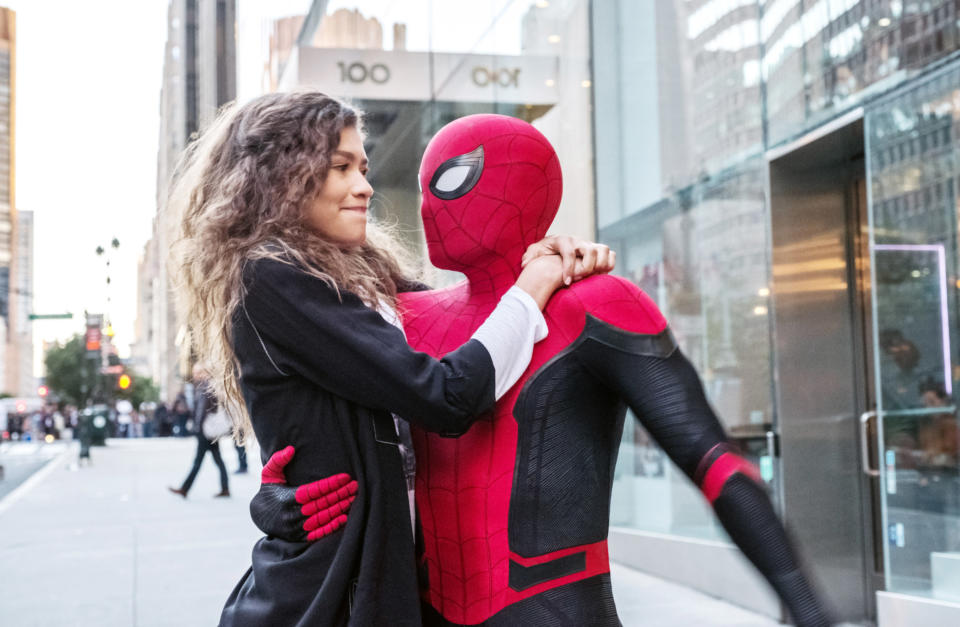 Tom as Spider-Man holding onto Zendaya's character MJ