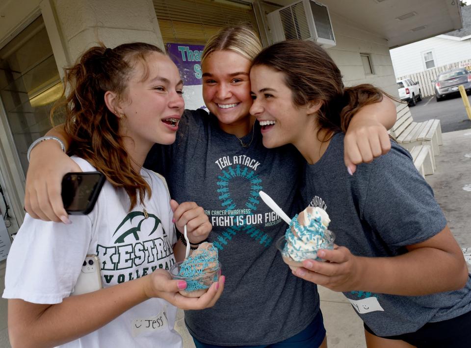 SMCC graduate Kate Collingsworth, a server at Lucy's Frozen Custard, laughs with former SMCC volleyball players sophomore Jessica Costlow and junior Molly Blanchett during Teal Tuesday.