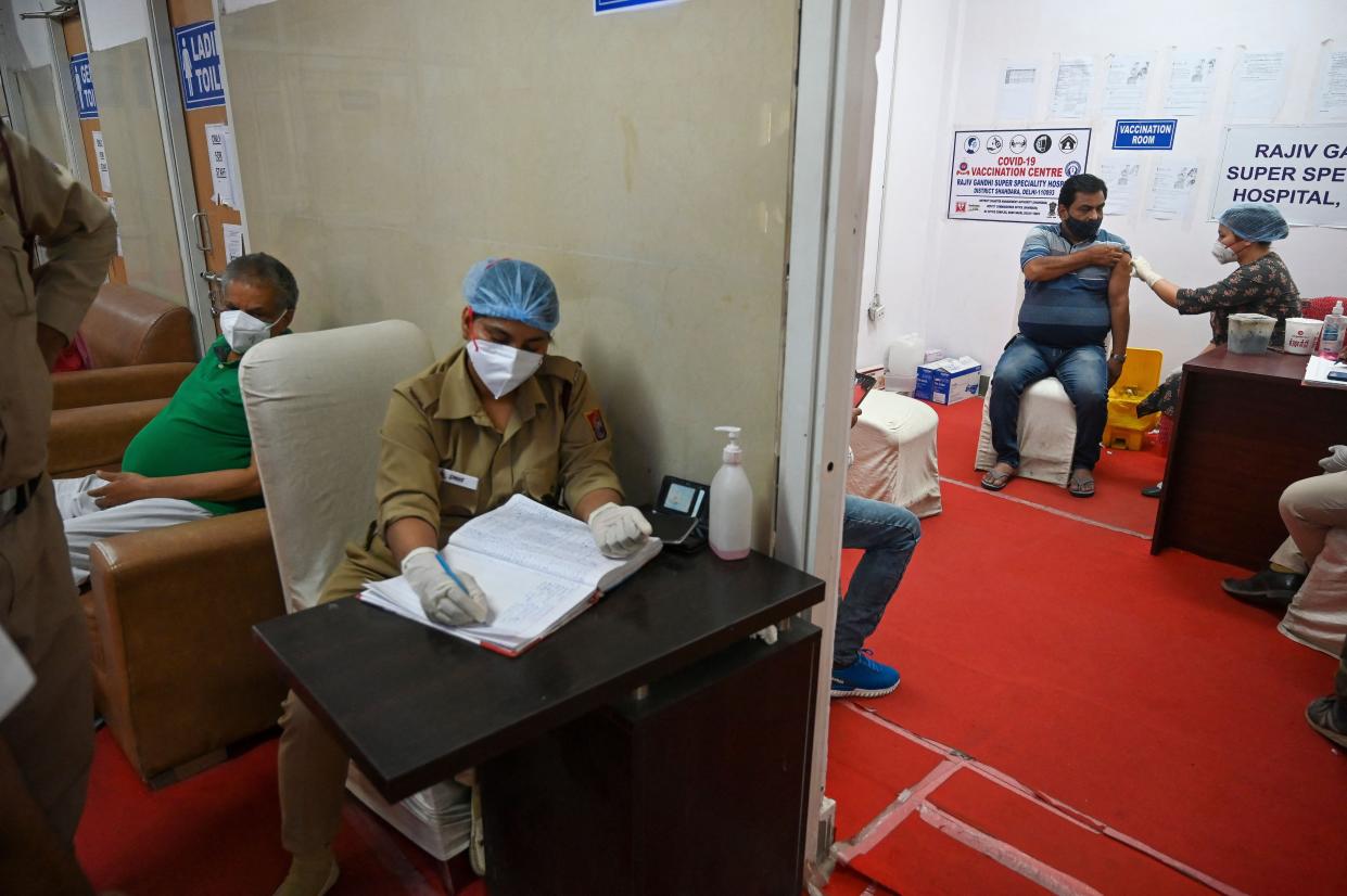 A medical worker inoculates a man with a dose of the Covishield Covid-19 coronavirus vaccine at Rajiv Gandhi Super Speciality, a hospital in New Delhi on April 29, 2021.