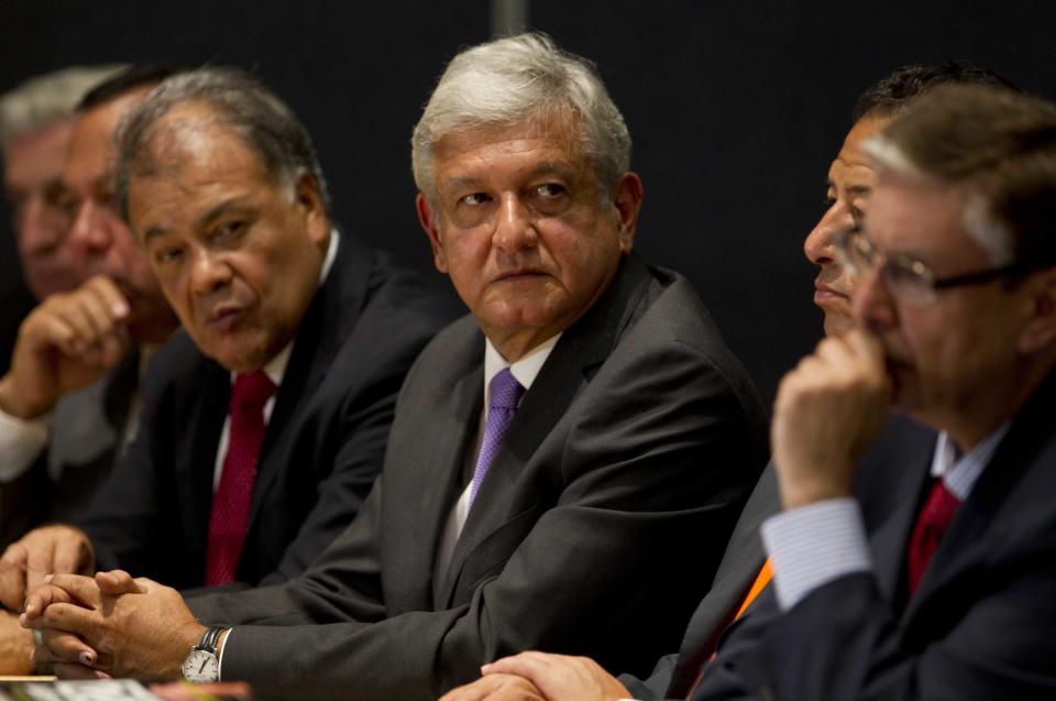 Andres Manuel Lopez Obrador, center, presidential candidate for the Democratic Revolution Party (PRD), attends a news conference in Mexico City, Thursday, July 12, 2012. Lopez Obrador says he will ask an electoral court to invalidate the results of the July 1 presidential election, charging there was vote buying and campaign overspending by the winner of official vote counts. (AP Photo/Eduardo Verdugo)