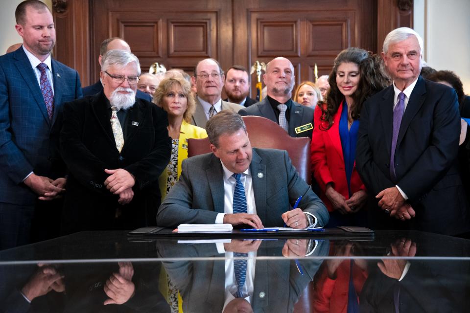 Gov. Chris Sununu, flanked by House and Senate members from both parties, signed the New Hampshire Legislature’s $15.2 billion biennial budget Tuesday, June 20, 2023.