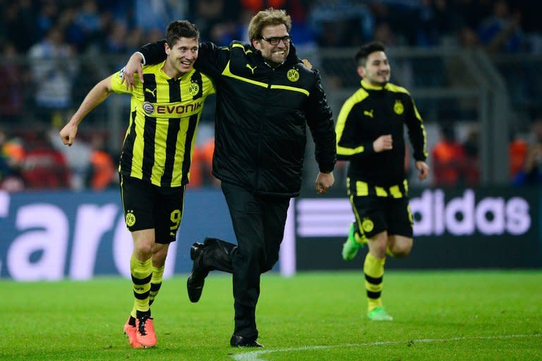 Borussia Dortmund coach Juergen Klopp celebrates with striker Robert Lewandowski (L) after they defeat Malaga 3-2 in Dortmund, western Germany on April 9, 2013. Klopp admitted they had ridden their luck as their victory put them in the Champions League's last four