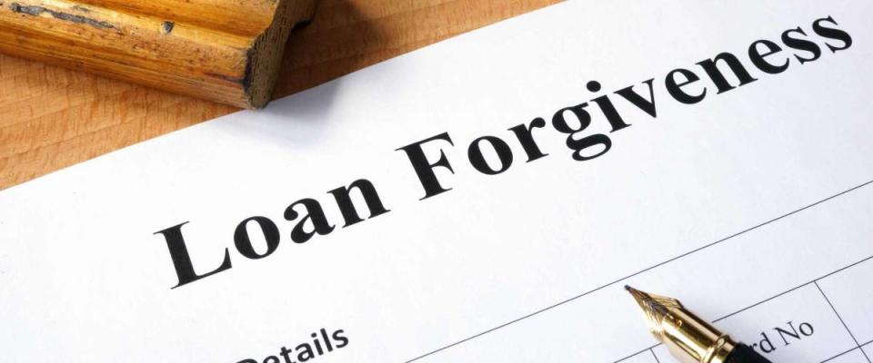 Loan forgiveness form on a wooden table.