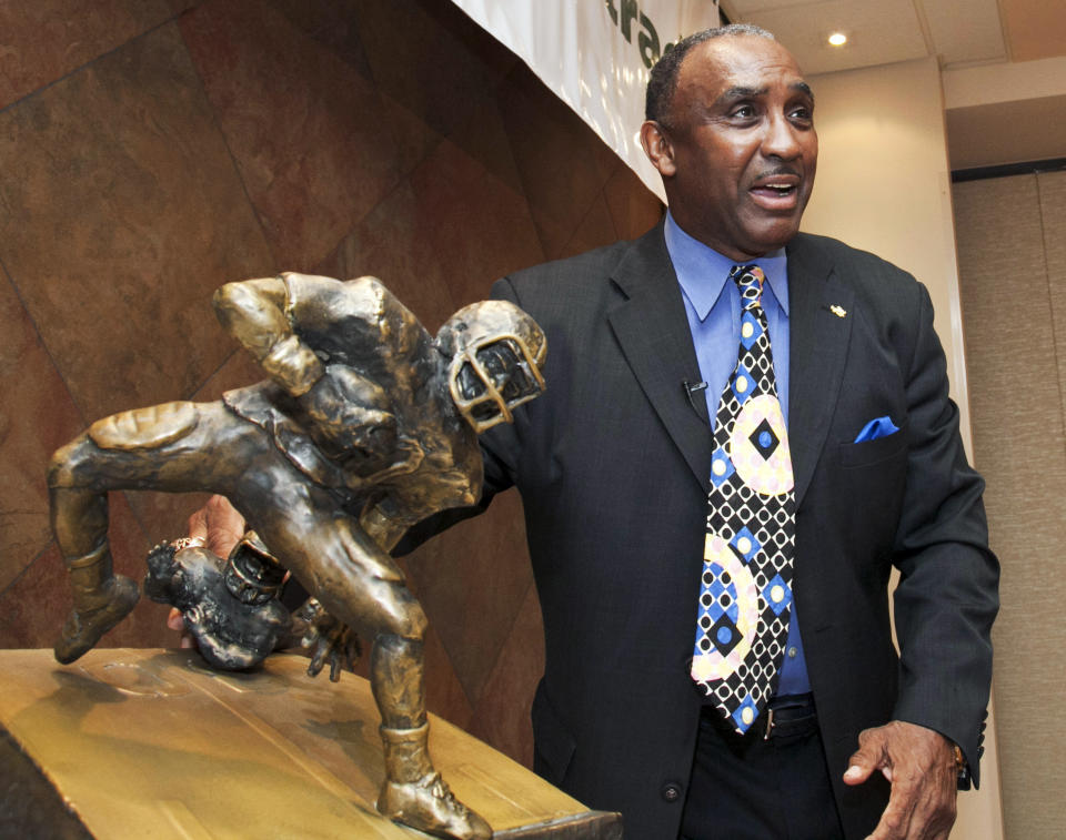 FILE - In this Tuesday, March 27, 2012, file photo, a new award to honor college football's top return specialist is announced by 1972 Nebraska Heisman Trophy winner Johnny Rodgers at a news conference in Omaha, Neb. The Johnny "The Jet" Rodgers Award is named for Rodgers, who is widely regarded as one of the top punt and kick returners in college football history. Rodgers’ electrifying 72-yard punt return for a touchdown was the signature play of a rare game that lived up to “Game of the Century” billing, helping No. 1 Nebraska defeat No. 2 Oklahoma 35-31 in the 1971 classic. Fifty years later, Rodgers still gets asked about the play. (AP Photo/Nati Harnik, File)