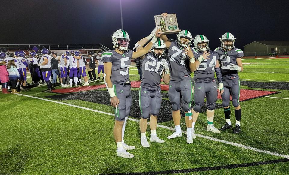 From left to right, Badin's Landyn Vidourek, Jack Walsh, Logan Neu, Henry Birchwell and Brady Imhoff hoist the Region 12 championship trophy. Badin reached the state semifinals for the first time since 1998.